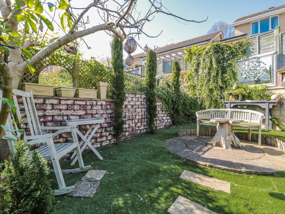 A garden with a chair and bench at 7 The Cedars in Wotton-Under-Edge