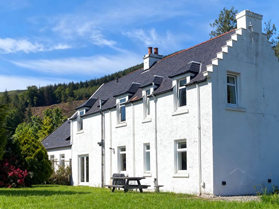 A house with windows and a garden at Argyll Farmhouse-Idyllic Setting-Sleeps10 in Dunoon