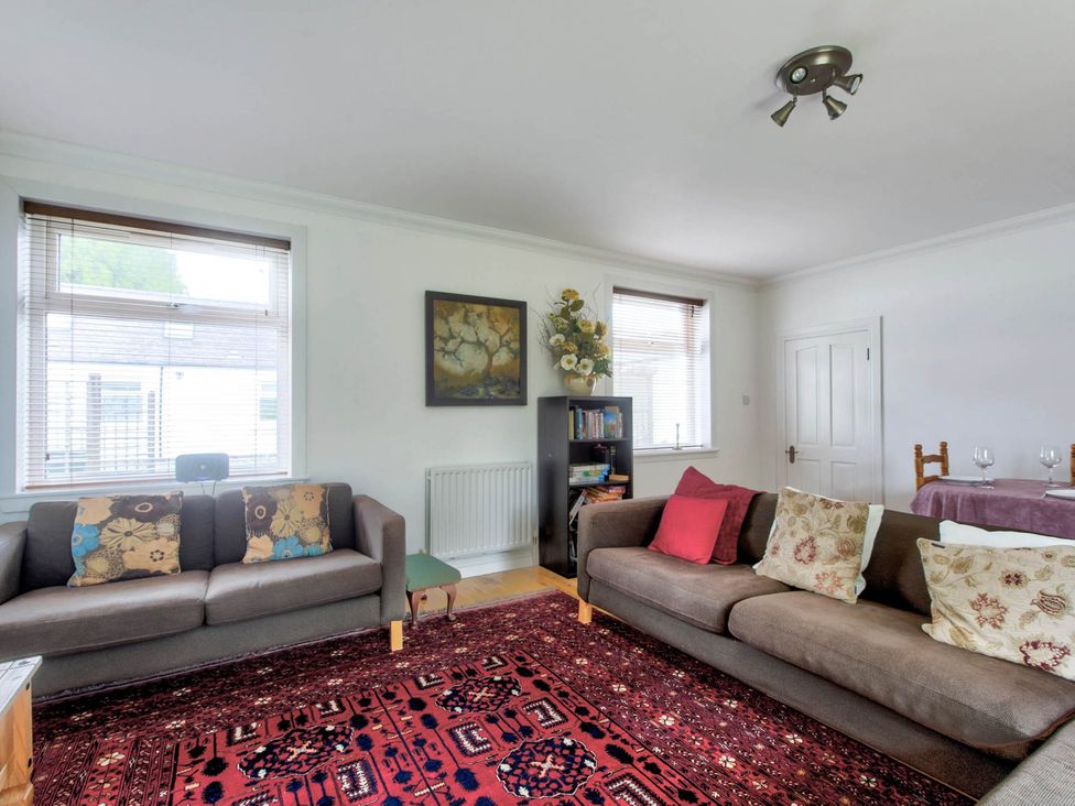 A living room with two sofas and a rug at Argyll Farmhouse-Idyllic Setting-Sleeps10 in Dunoon