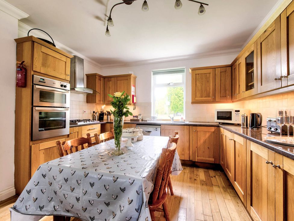 A kitchen with a table and chairs at Argyll Farmhouse-Idyllic Setting-Sleeps10 in Dunoon