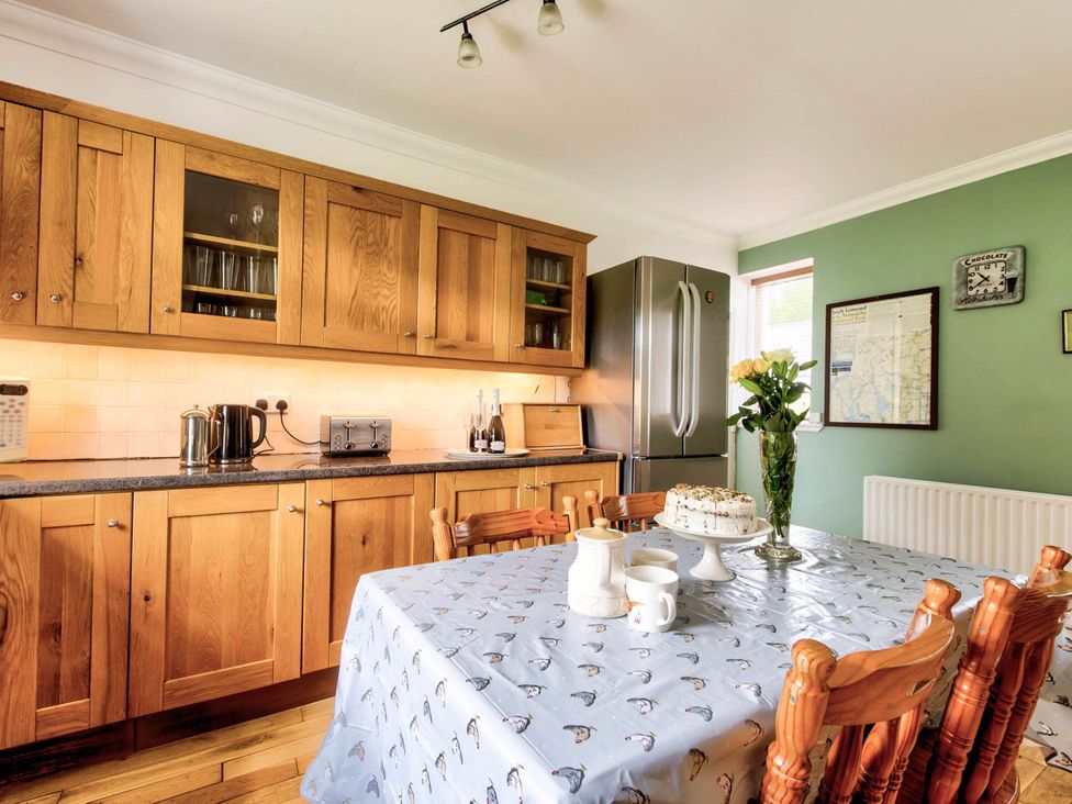 A kitchen with a dining table and chairs at Argyll Farmhouse-Idyllic Setting-Sleeps10 in Dunoon