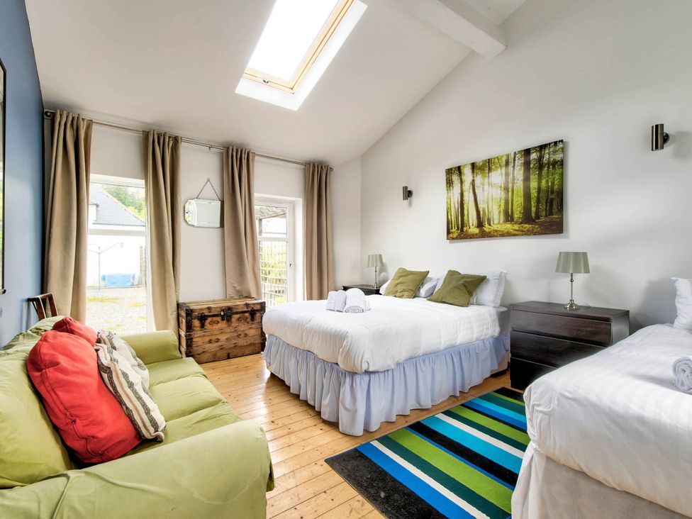 A bedroom with two beds and a chest at Argyll Farmhouse-Idyllic Setting-Sleeps10 in Dunoon