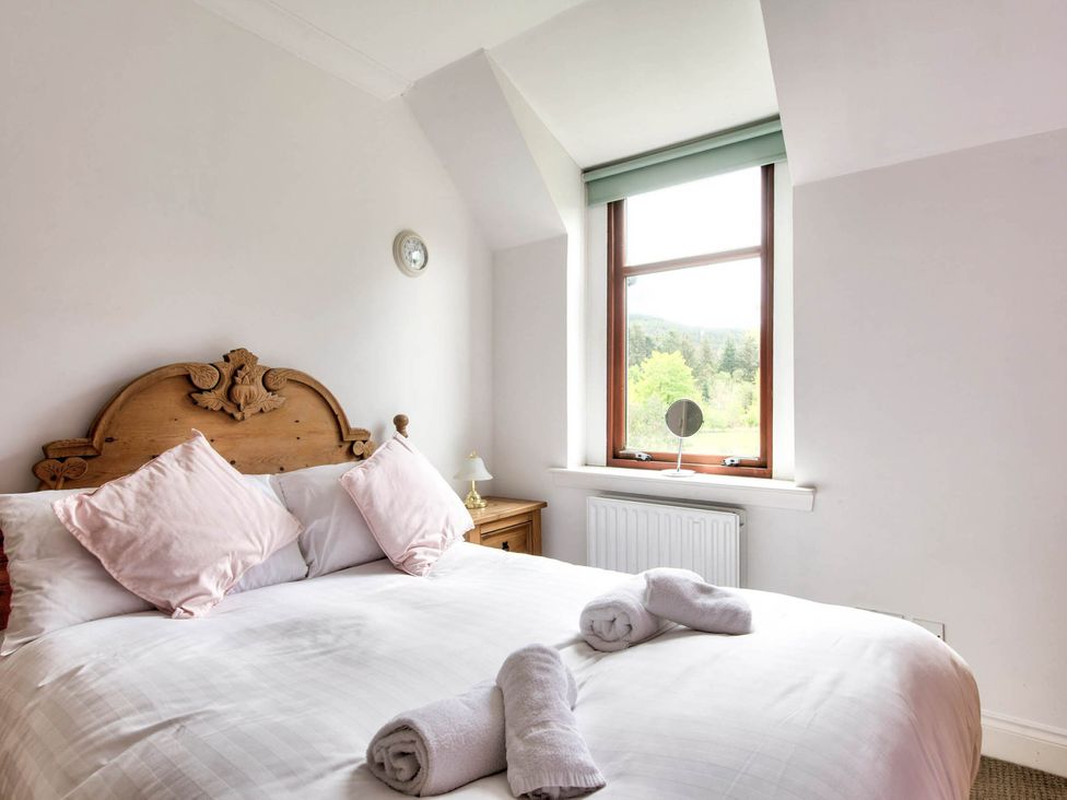 A bedroom with a bed and window at Argyll Farmhouse-Idyllic Setting-Sleeps10 in Dunoon