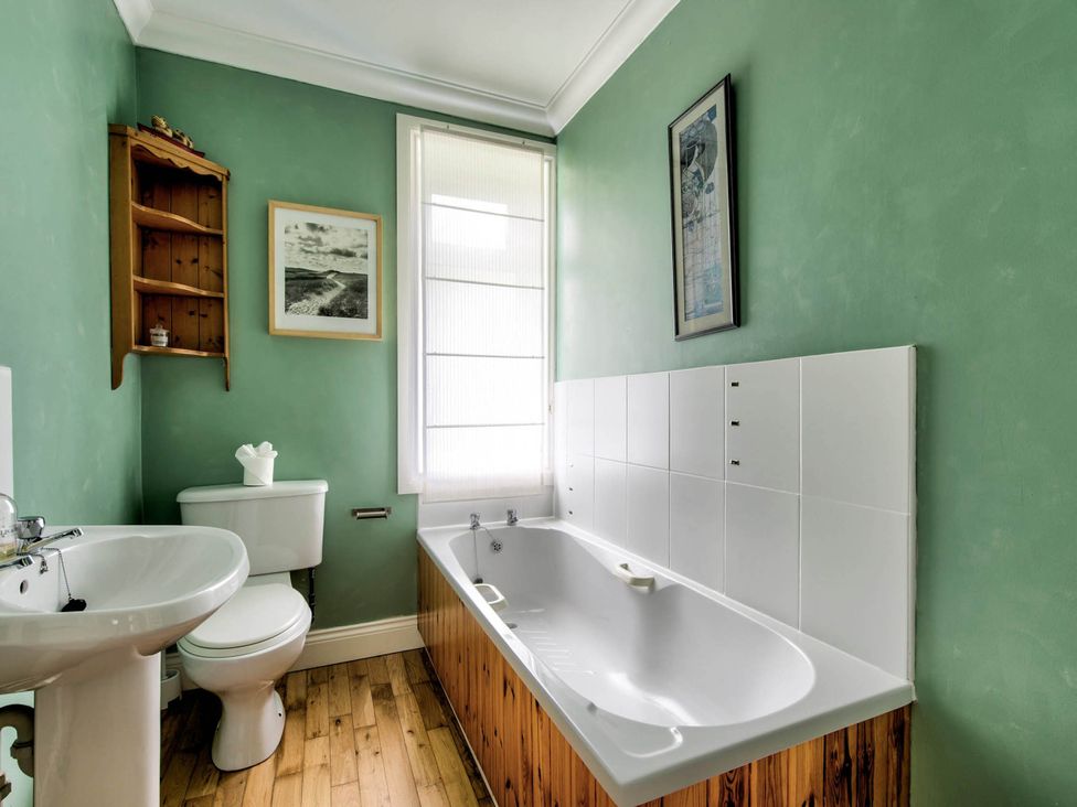 A bathroom with a bathtub, toilet, and sink at Argyll Farmhouse-Idyllic Setting-Sleeps10 in Dunoon