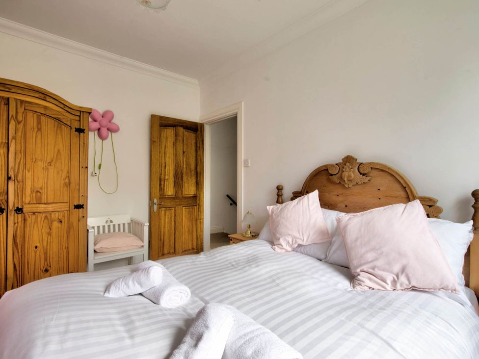 A bedroom with a bed and wardrobe at Argyll Farmhouse-Idyllic Setting-Sleeps10 Dunoon