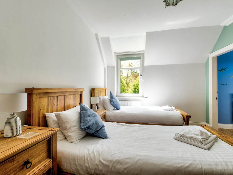 A bedroom with two beds and a window at Argyll Farmhouse-Idyllic Setting-Sleeps10 in Dunoon