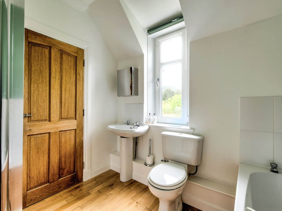A bathroom with sink, toilet, and window at Argyll Farmhouse-Idyllic Setting-Sleeps10 in Dunoon