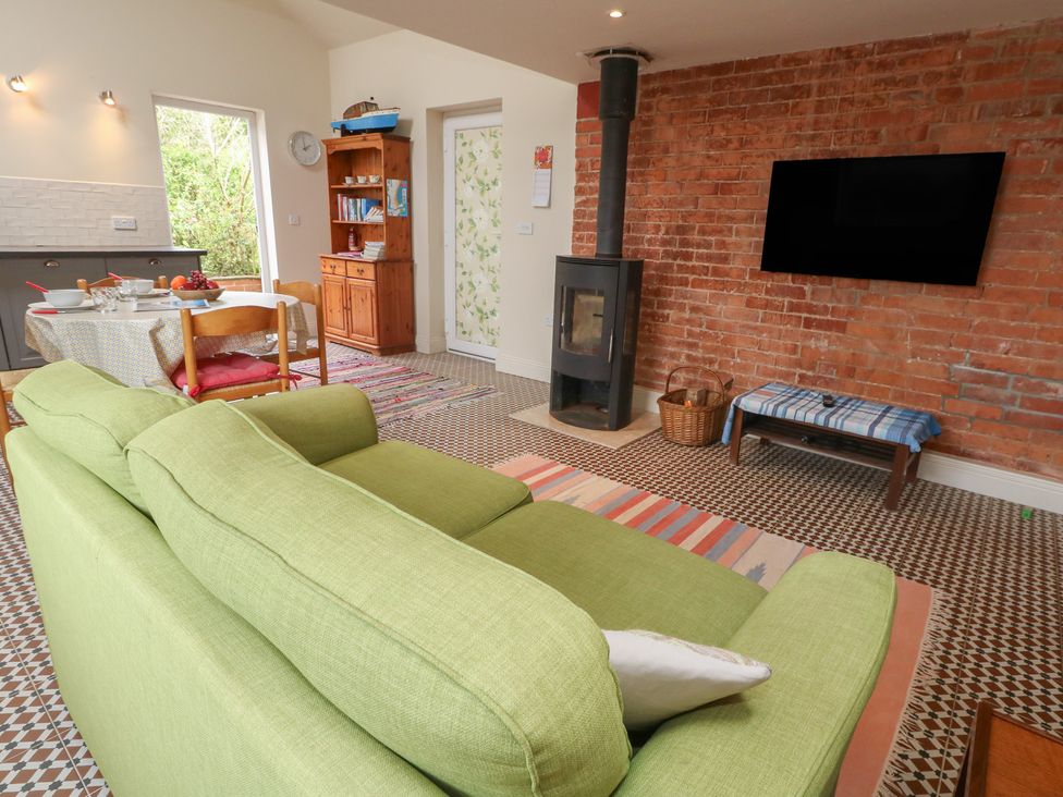 A living room with a sofa and dining table at Millmead House Annex in Portesham