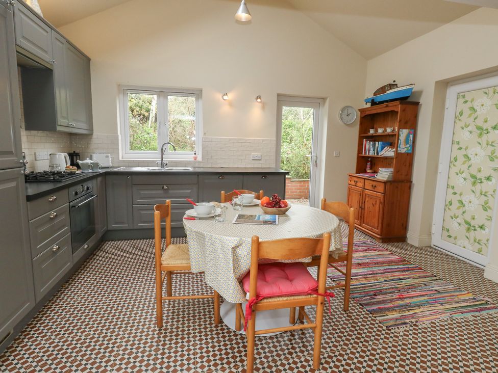 A kitchen with a dining table and chairs at Millmead House Annex Portesham
