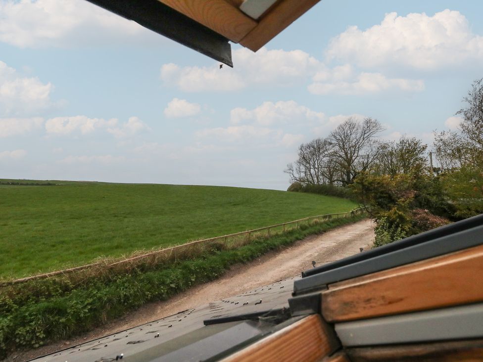 A view of a green field and a rural road at Millmead House Annex Portesham