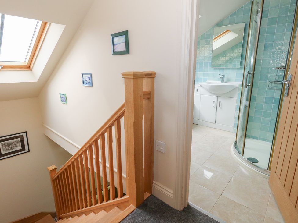 A staircase leading to a bathroom with a shower at Millmead House Annex Portesham