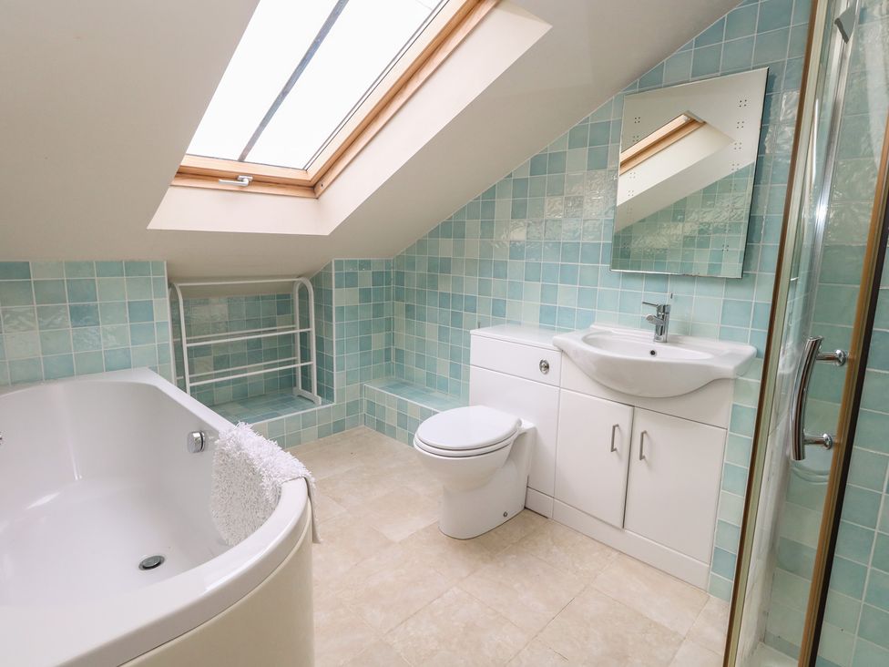 A bathroom with a bath, toilet, and sink at Millmead House Annex Portesham