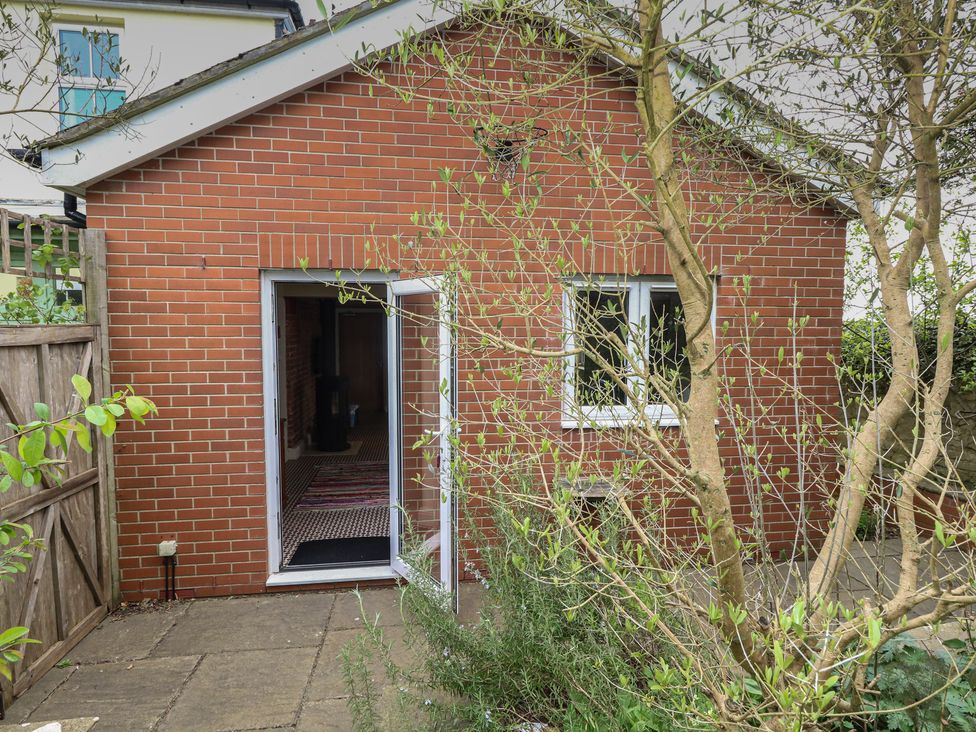 An outdoor view of a brick structure with plants around at Millmead House Annex Portesham