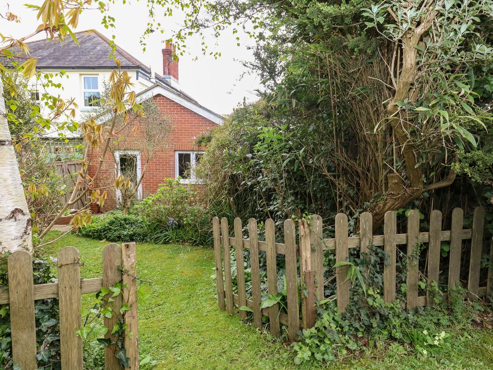 A garden with a wooden fence and plants at Millmead House Annex Portesham