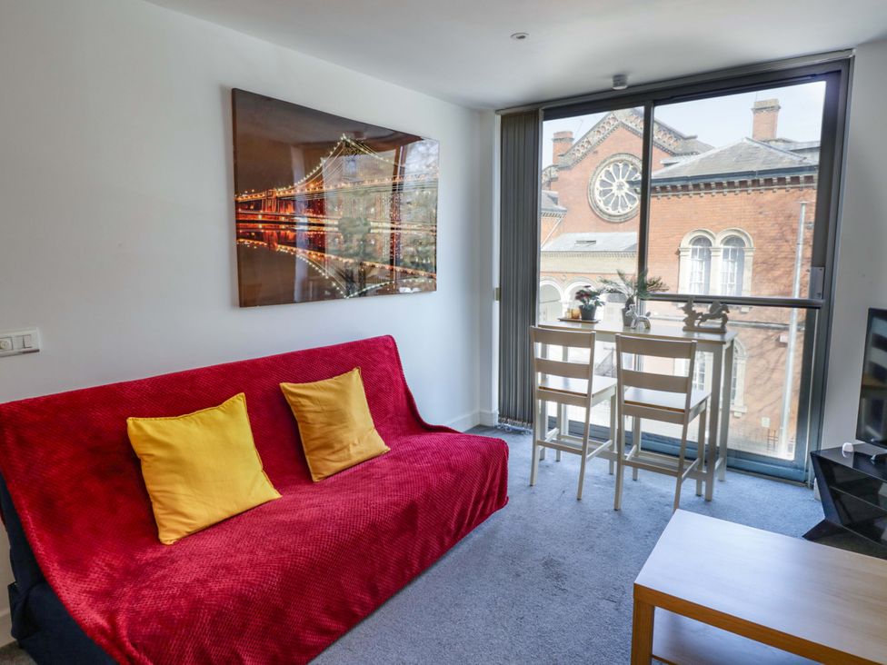 A living room with a sofa and table at Apartment 26 in Birmingham