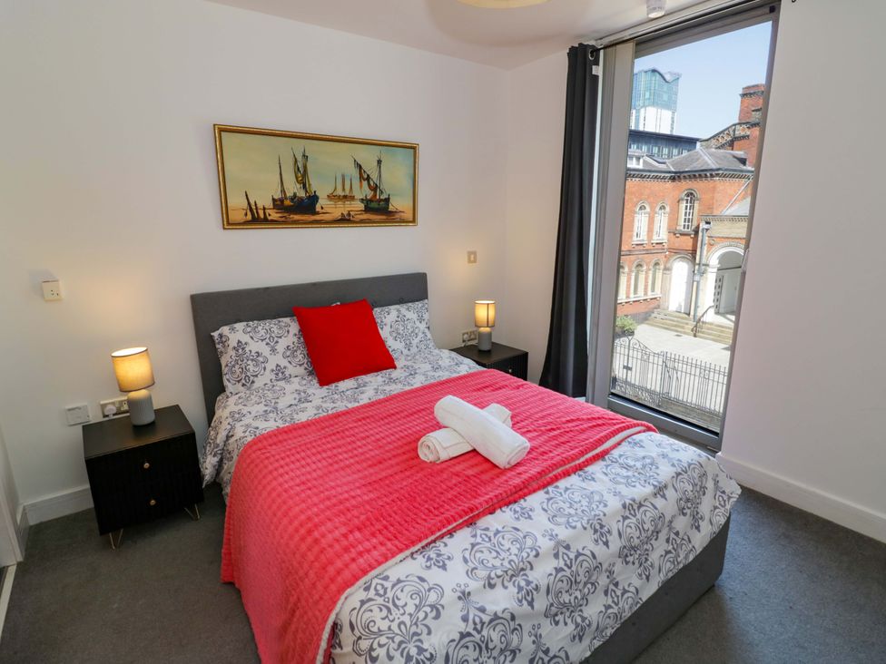 A bedroom with a bed and window at Apartment 26 Birmingham