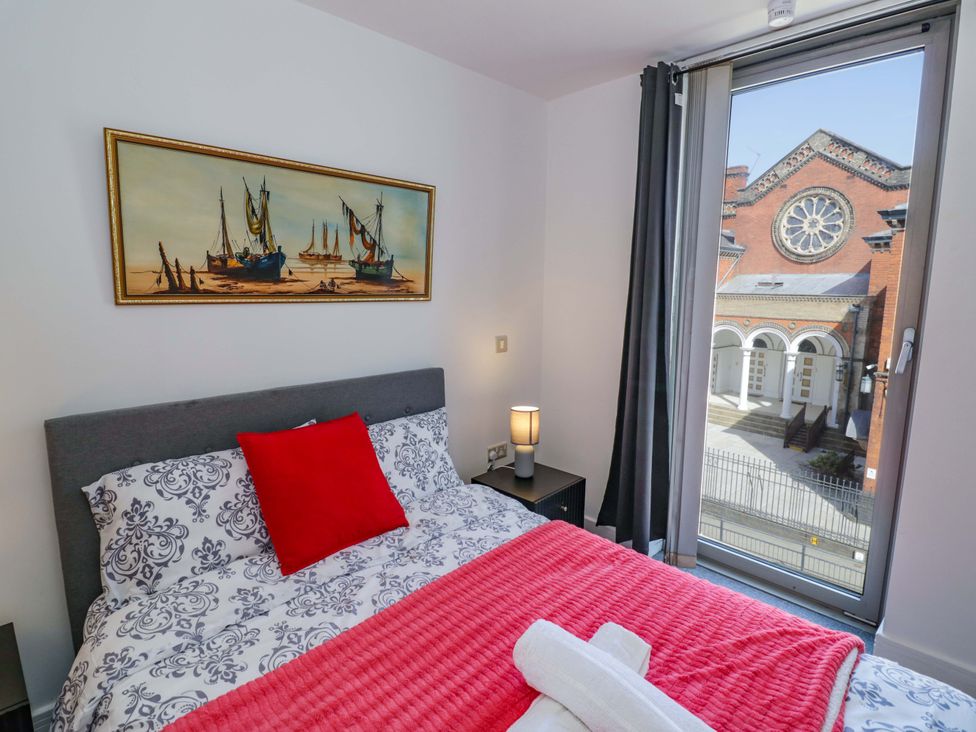 A bedroom with a bed and window at Apartment 26 in Birmingham