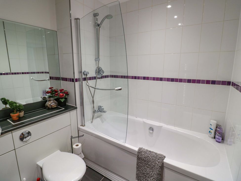 A bathroom with a bathtub and shower at Apartment 26 in Birmingham