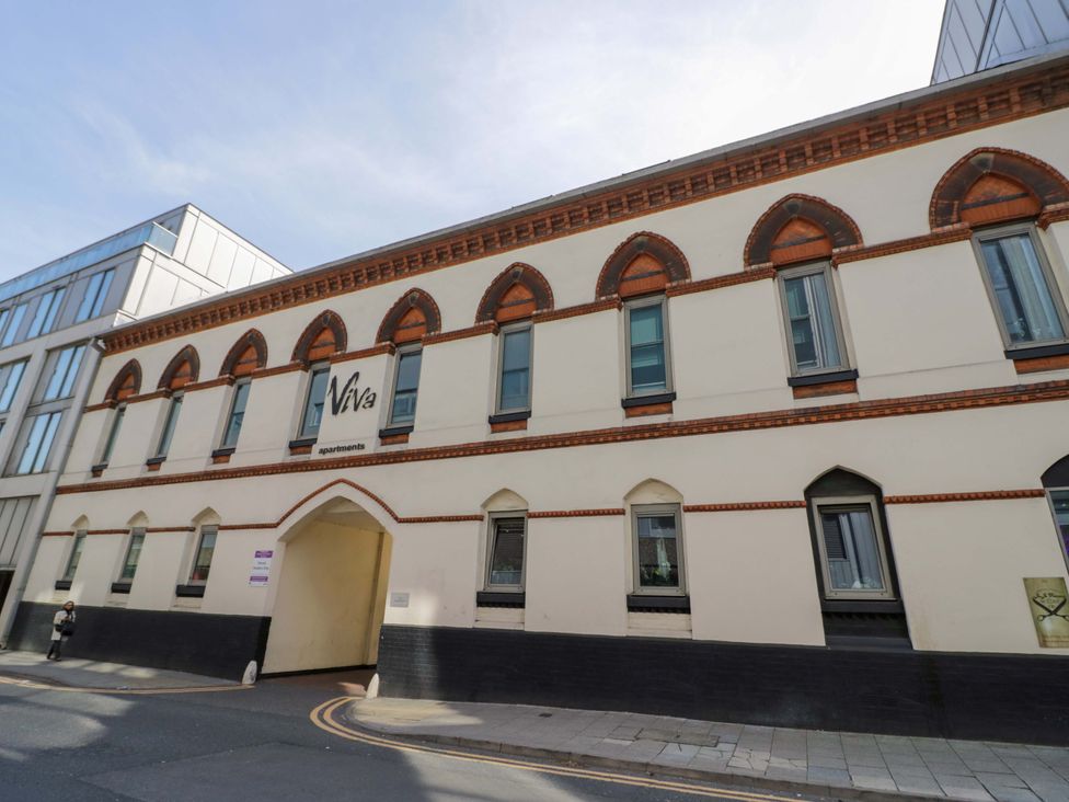 A building with windows and a sign at Viva apartments in Birmingham