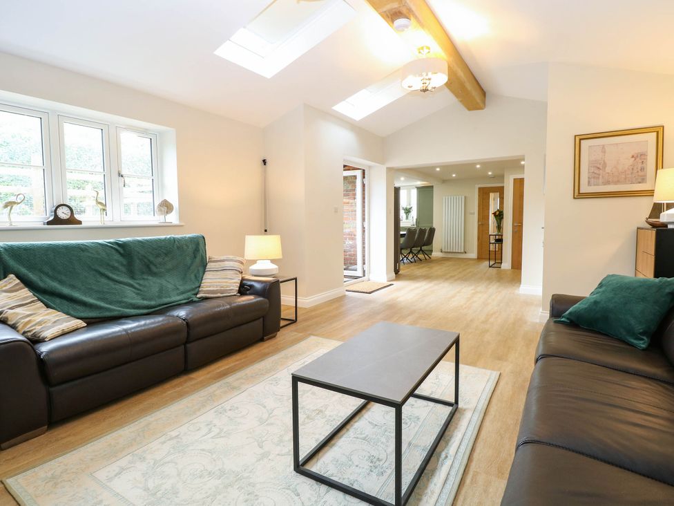 A living room with sofas and a coffee table at Bramley Cottage in Worlingham