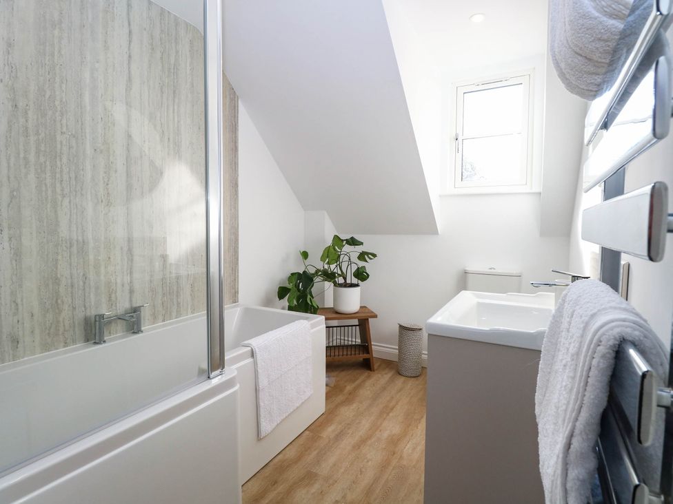 A bathroom with a bathtub and sink at Bramley Cottage in Worlingham