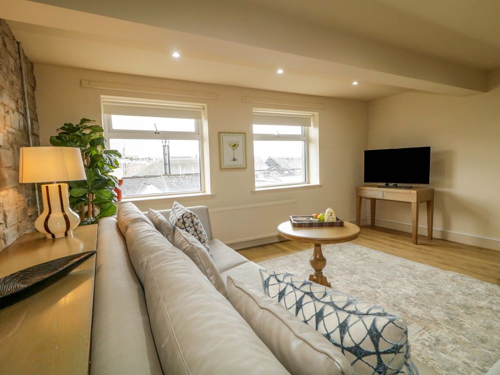 A living room with a sofa and TV at Apartment 1 in Londonderry