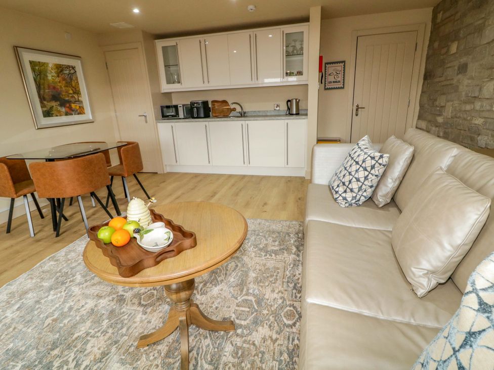 A living room with a coffee table and dining area at Apartment 1 Londonderry
