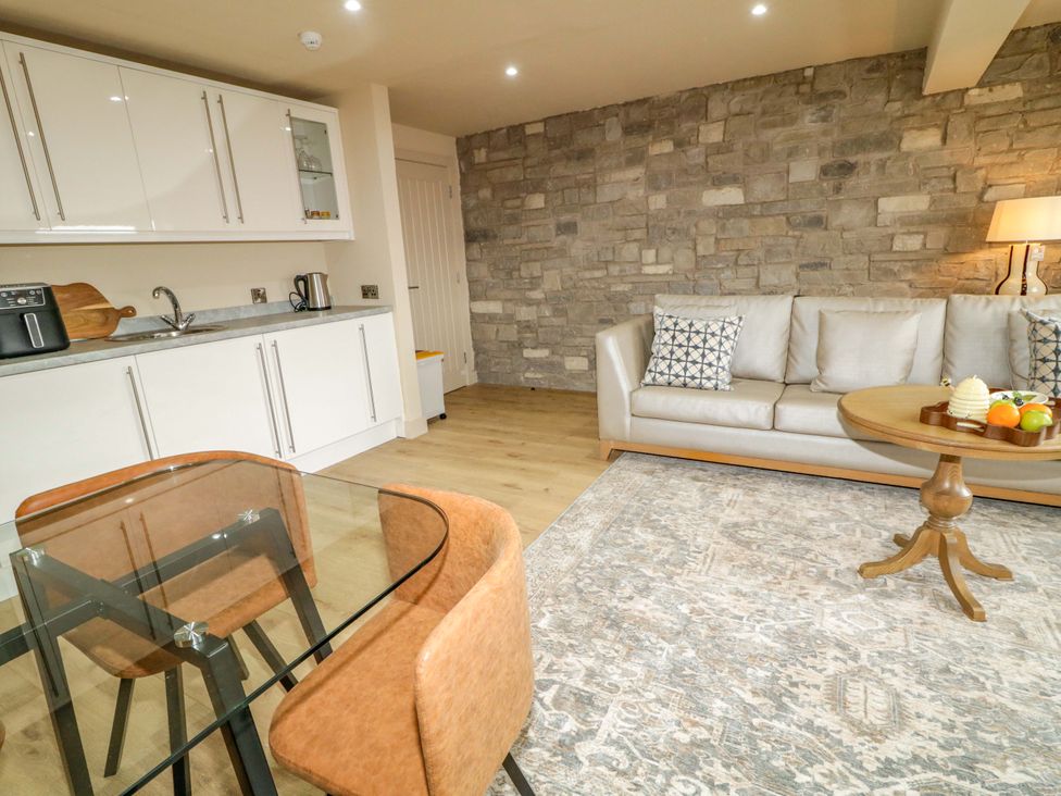 A living room with a sofa and a dining area at Apartment 1 Londonderry