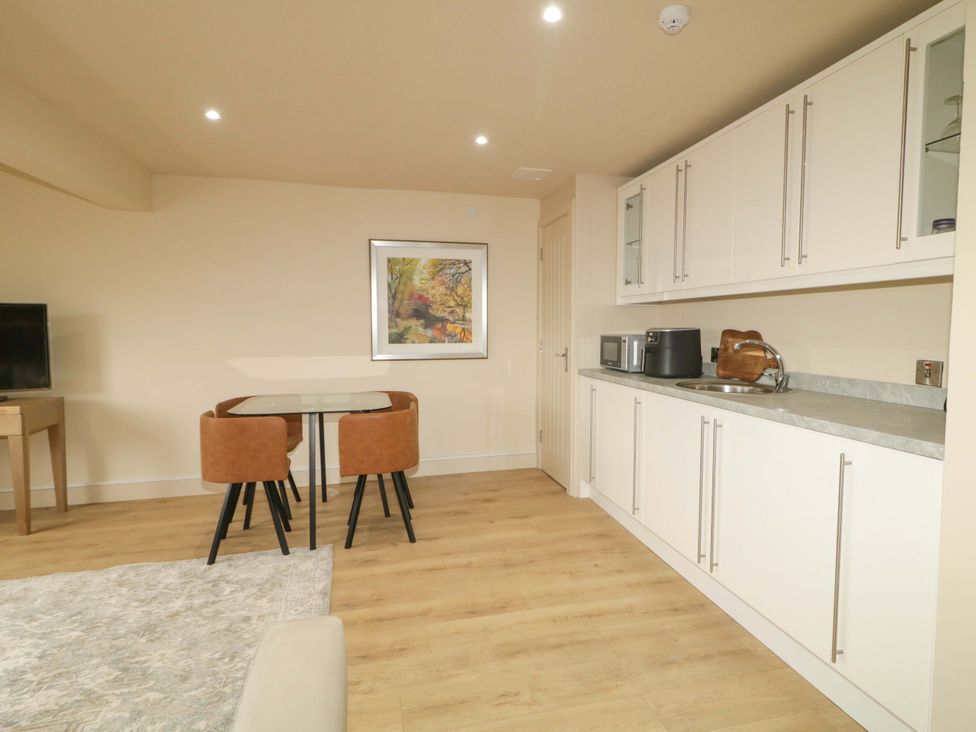 A kitchen with a dining table and chairs at Apartment 1 in Londonderry