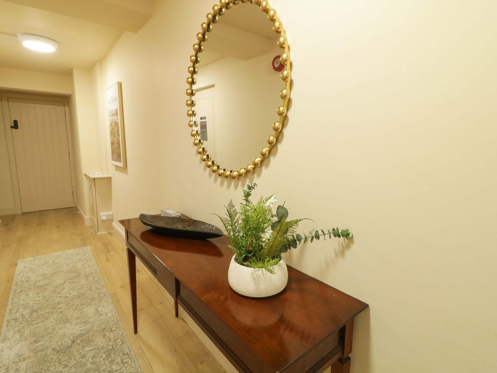 A hallway with a table and a plant at Apartment 1 in Londonderry