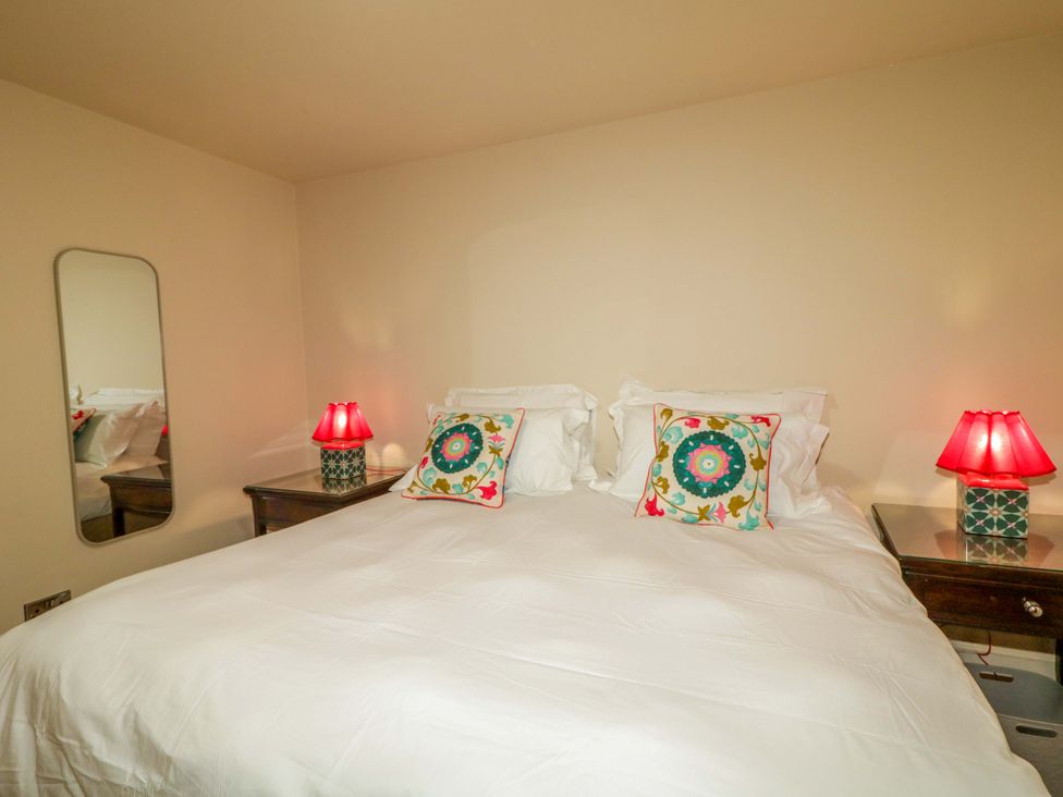 A bedroom with a bed and nightstands at Apartment 1 Londonderry