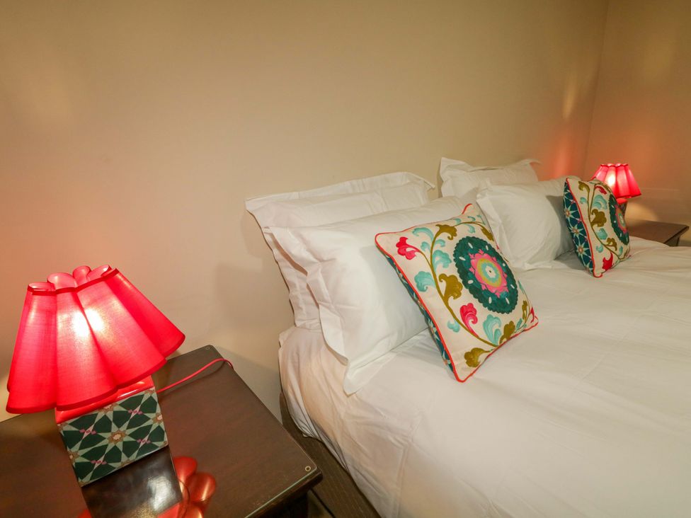 A bedroom with a bed and lamps at Apartment 1 Londonderry