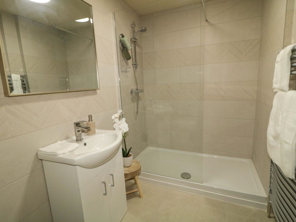 A bathroom with a shower and washbasin at Apartment 1 in Londonderry