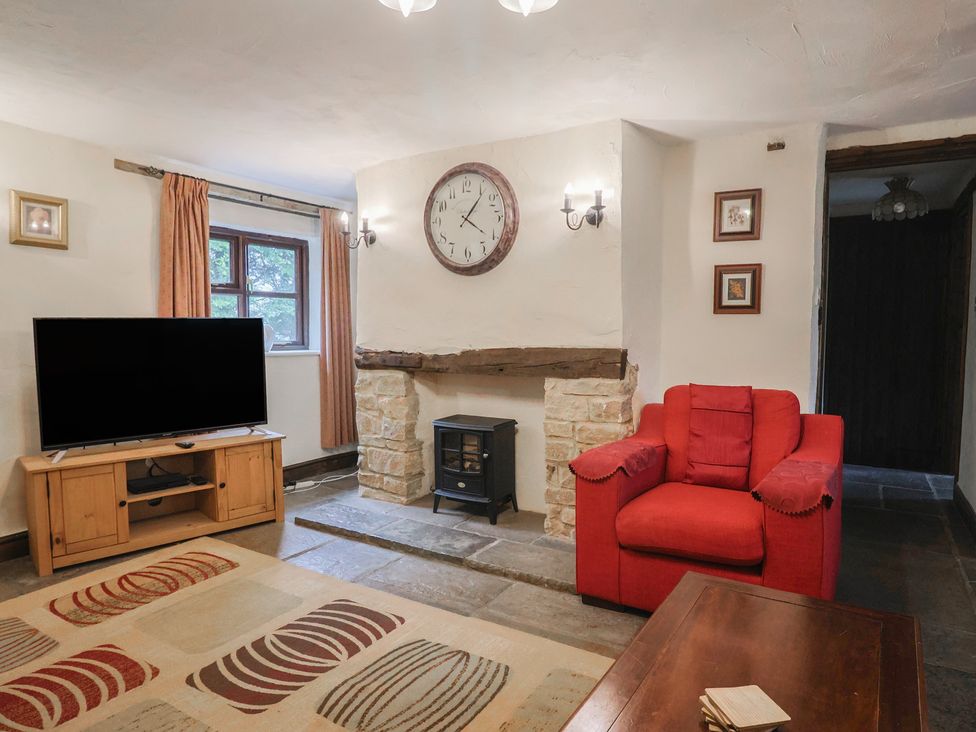 A living room with a television and fireplace at Cider House in Hawkchurch