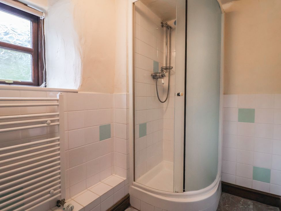 A bathroom with shower and radiator at Cider House in Hawkchurch