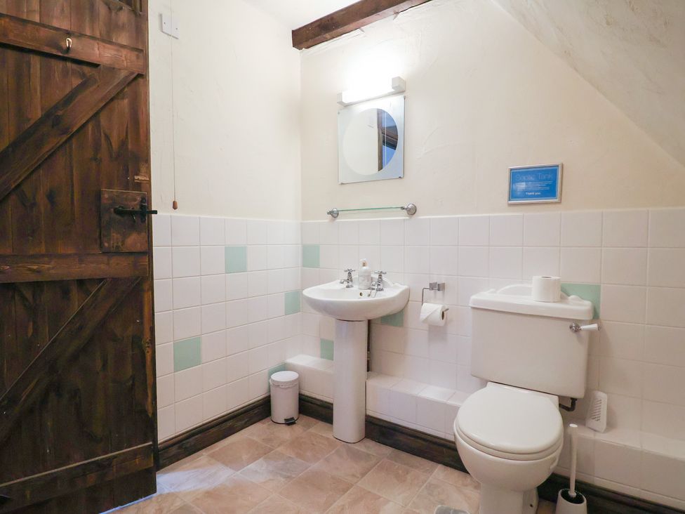 A bathroom with a sink and toilet at Cider House in Hawkchurch