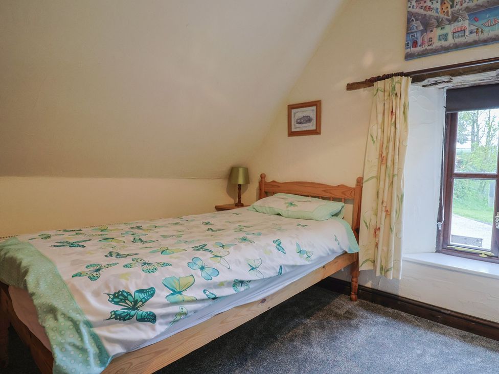 A bedroom with a bed and a window at Cider House in Hawkchurch