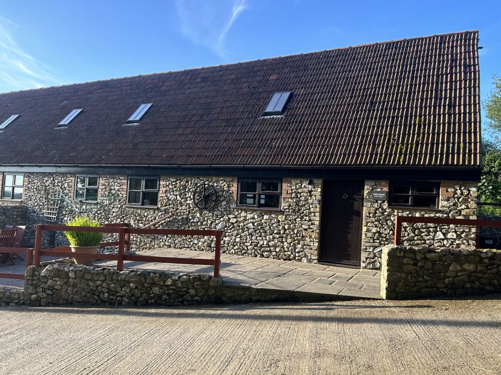An exterior view of a stone building with a tiled roof at Cider House in Hawkchurch