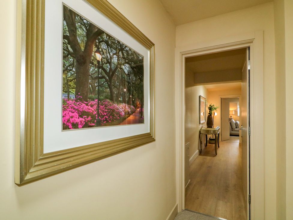 A hallway with a framed picture and a table at Apartment 2 in Derry