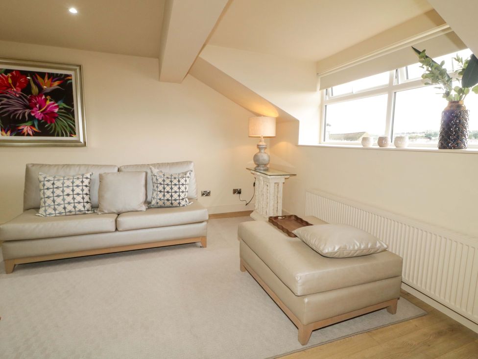 A living room with a sofa and lamp at Apartment 2 in Derry