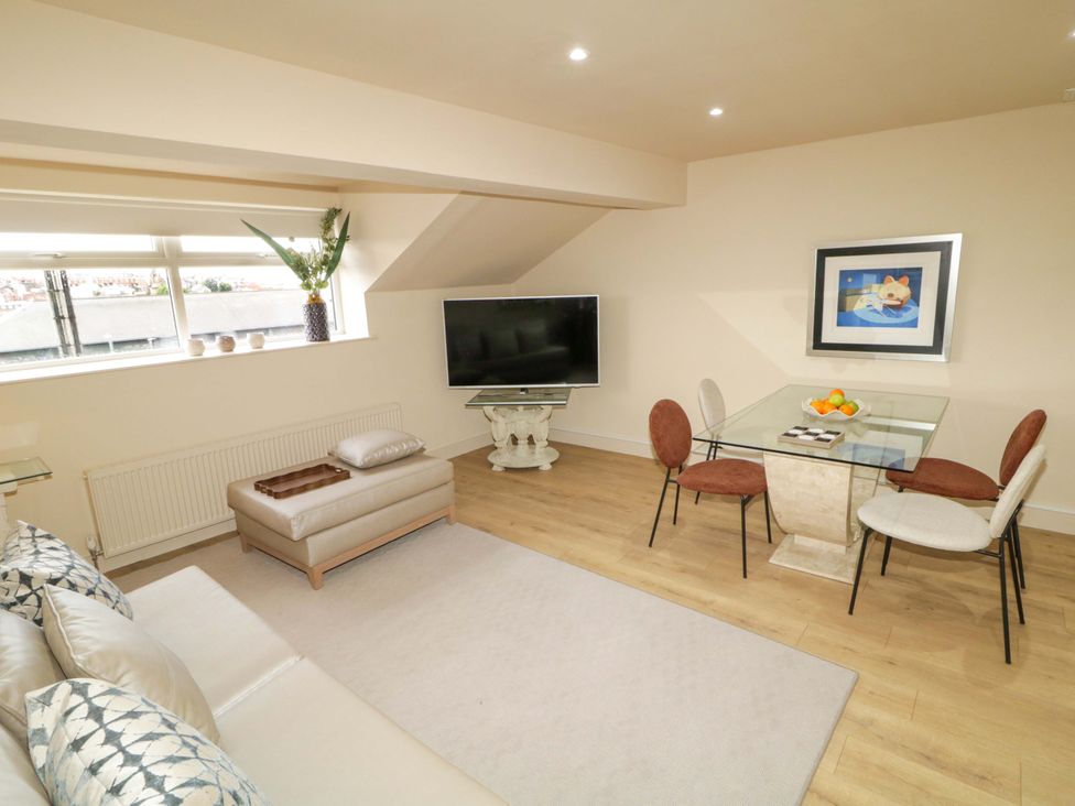 A living room with a sofa and dining table at Apartment 2 in Derry