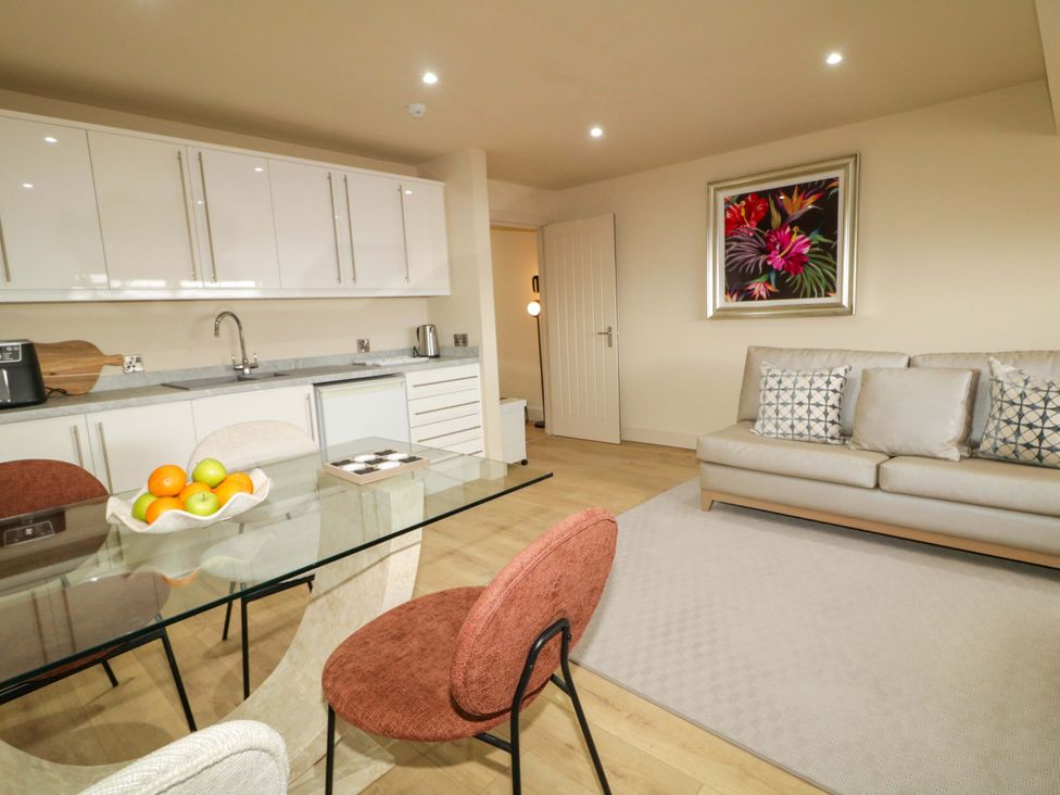 A living room and kitchen area with table and chairs at Apartment 2 in Derry
