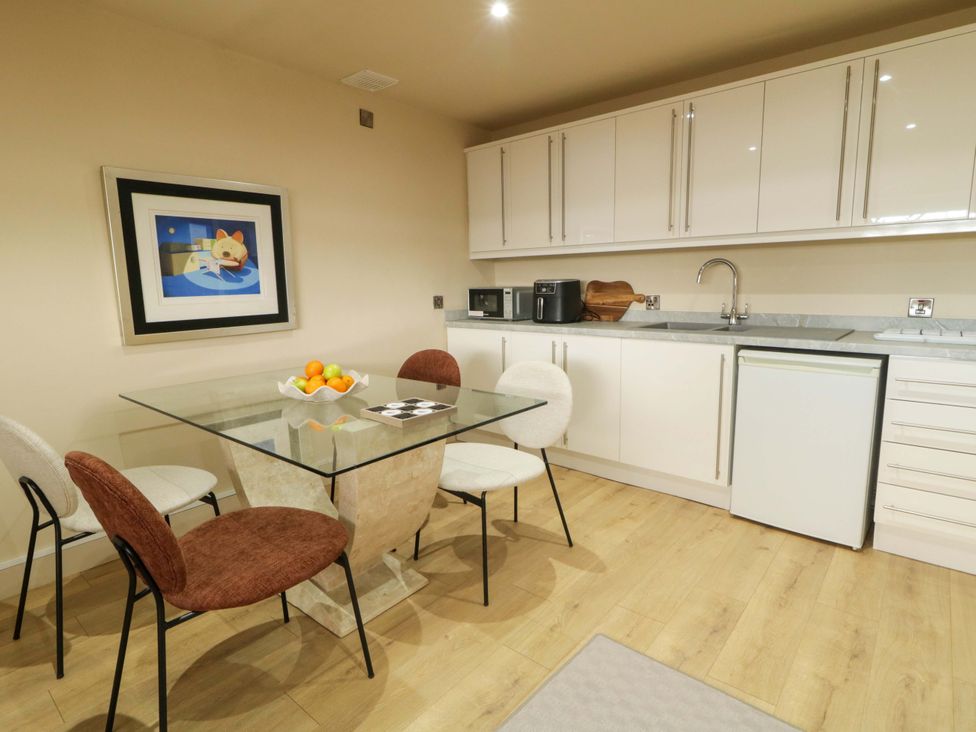 A kitchen with a table and chairs at Apartment 2 in Derry
