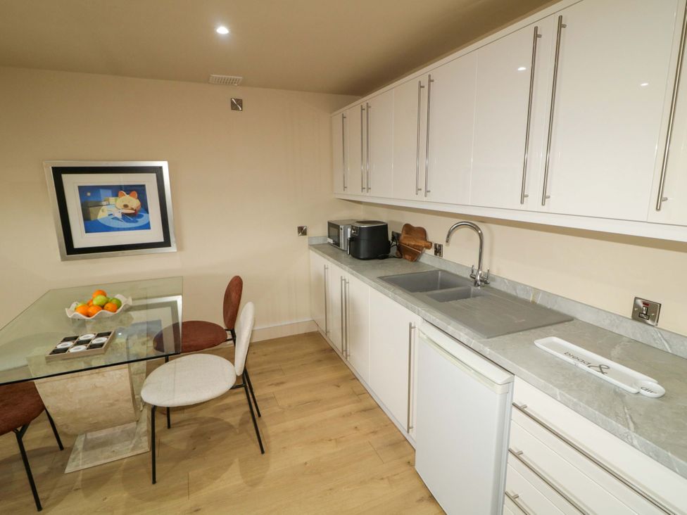 A kitchen with a table and chairs at Apartment 2 in Derry