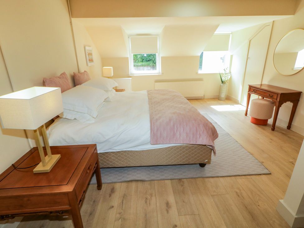 A bedroom with a bed and nightstand at Apartment 2 Derry