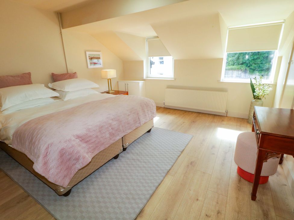 A bedroom with a bed and table at Apartment 2 in Derry