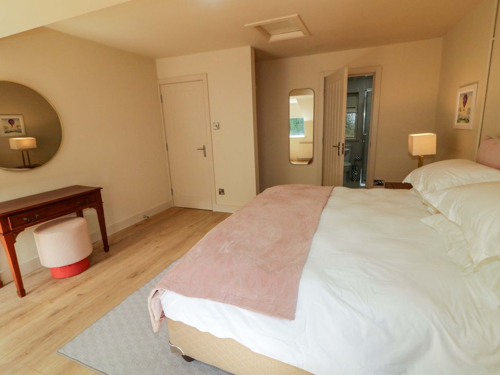 A bedroom with a bed and mirror at Apartment 2 in Derry