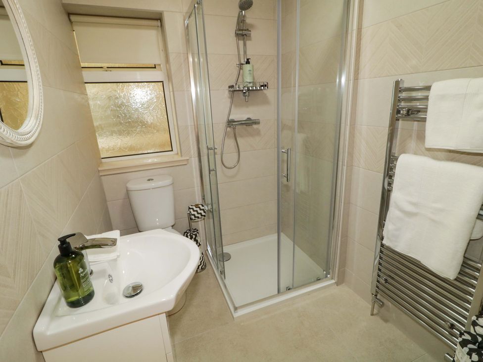 A bathroom with a shower, sink, and toilet at Apartment 2 in Derry