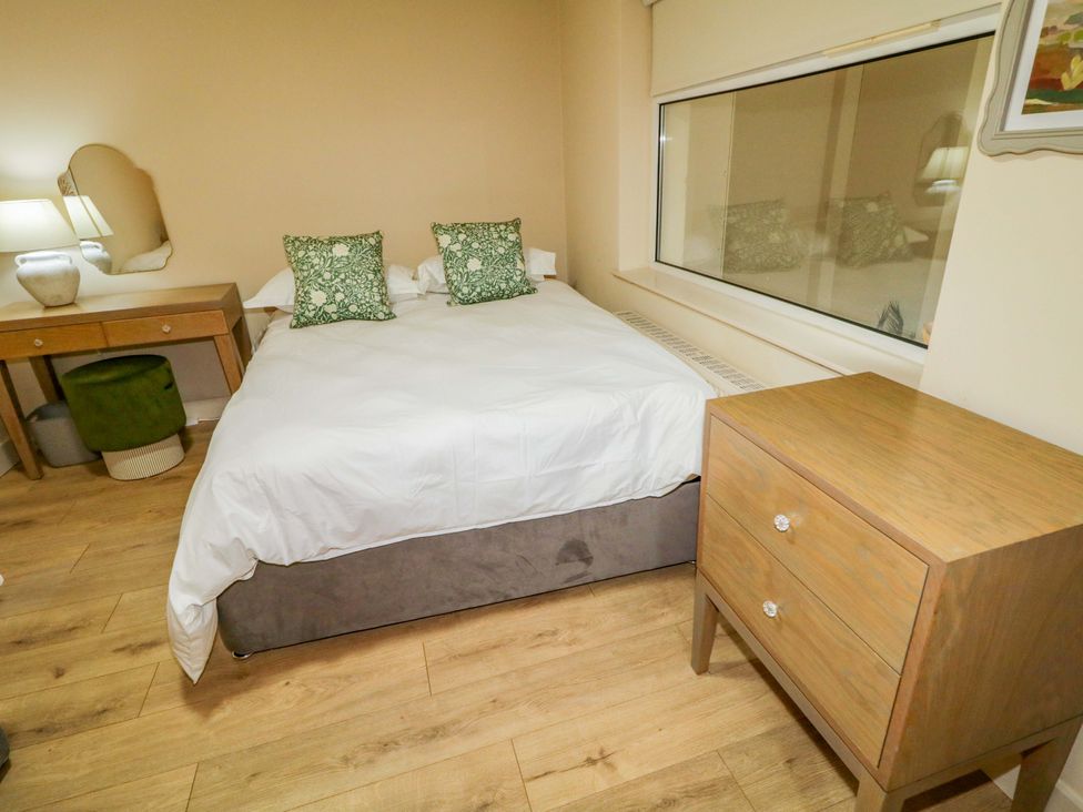 A bedroom with a bed and nightstand at Apartment 2 Derry
