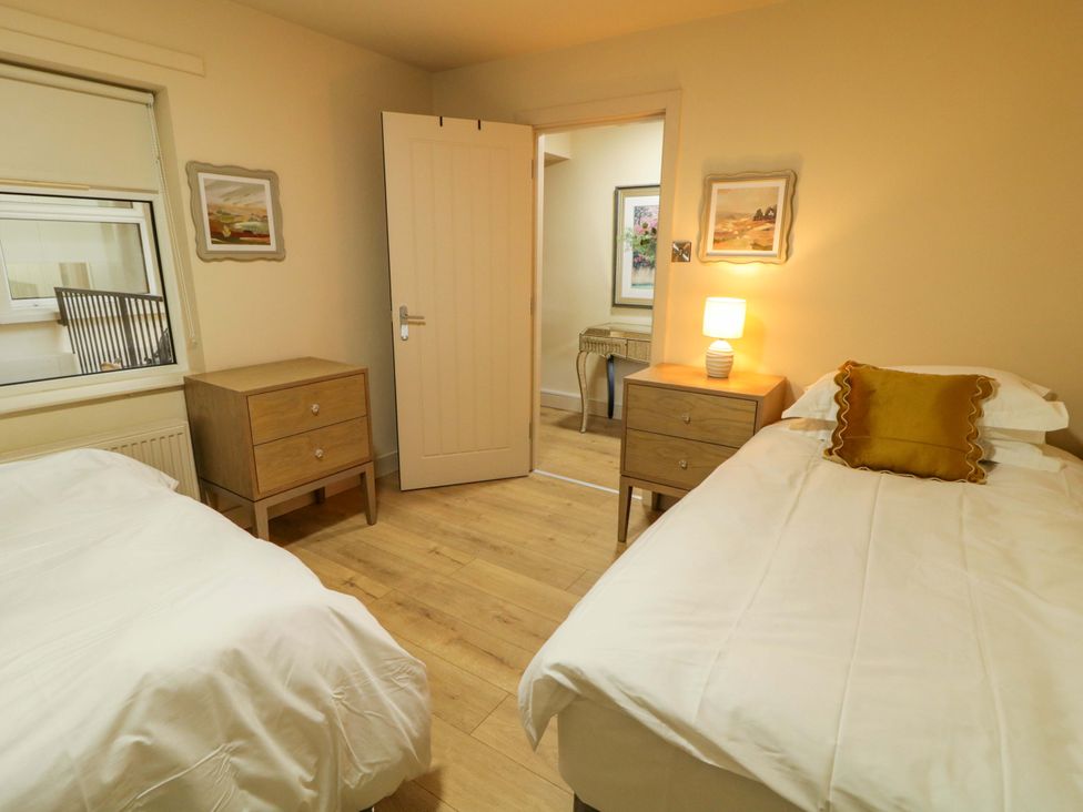 A bedroom with two beds and nightstands at Apartment 2 in Derry